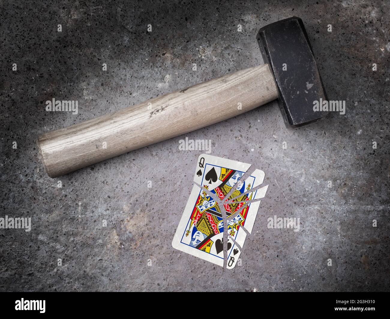 Hammer with a broken card, queen of spades Stock Photo Alamy