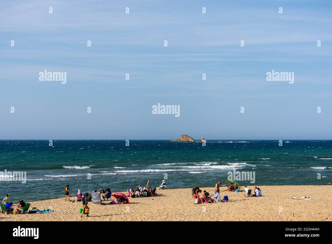 Group of families on the beach, summer vacation. Stock Photo