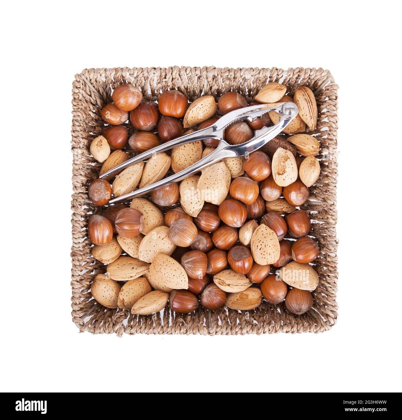 Mixed nuts in a woven basket with nut cracker Stock Photo Alamy