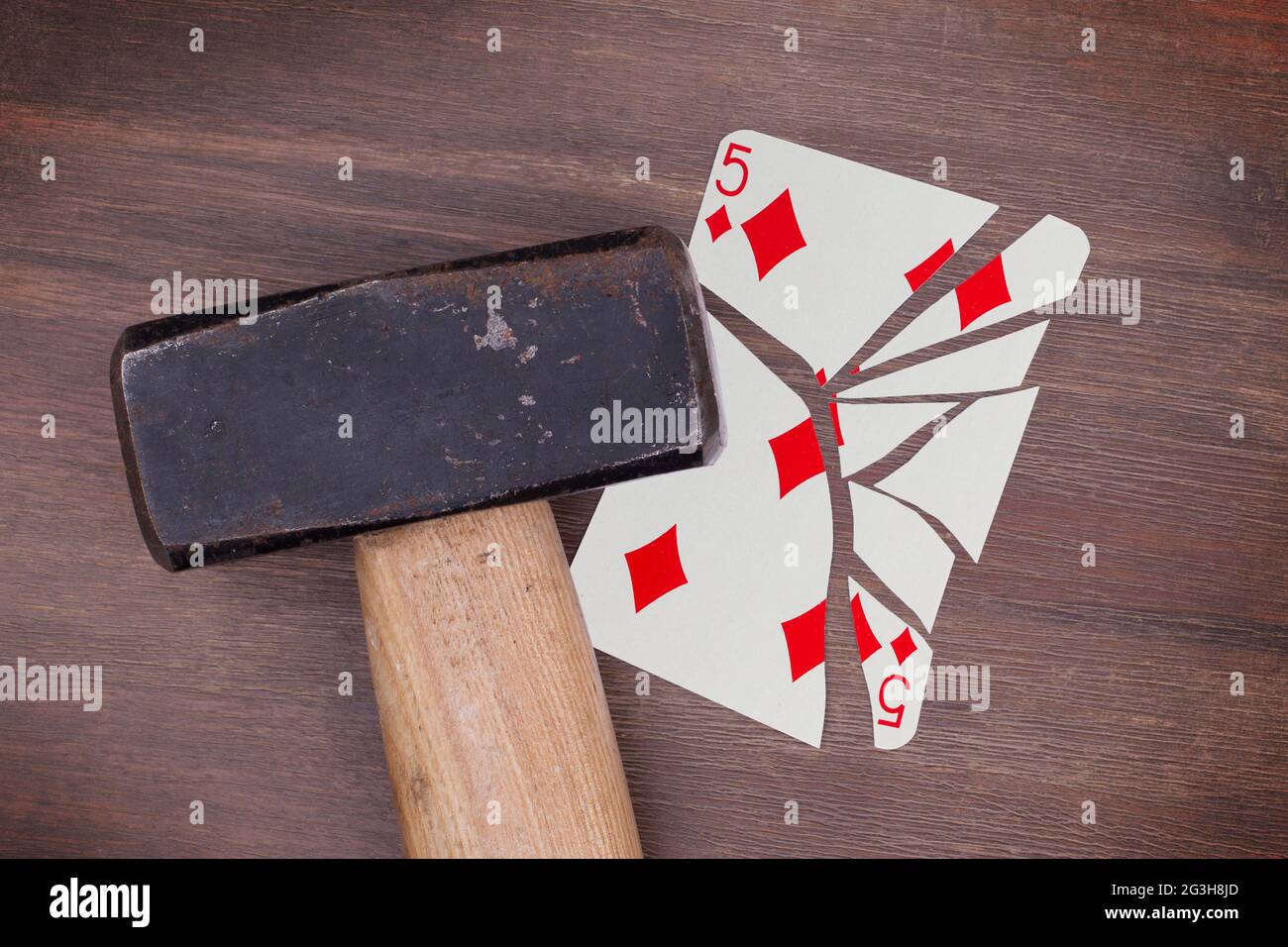 Hammer with a broken card, five of diamonds Stock Photo Alamy