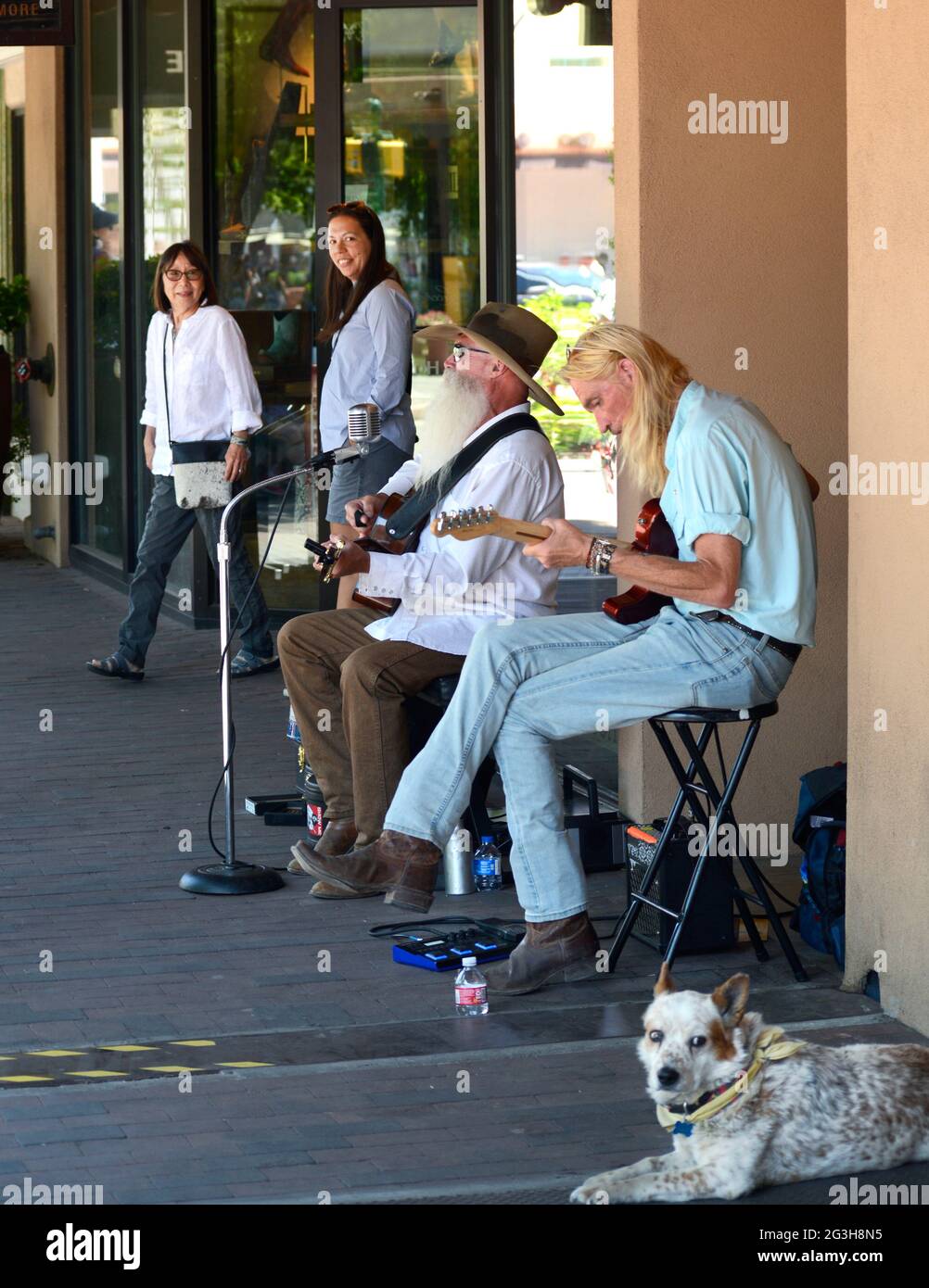 Street musicians and buskers perform for tips on a sidewalk in Santa Fe ...