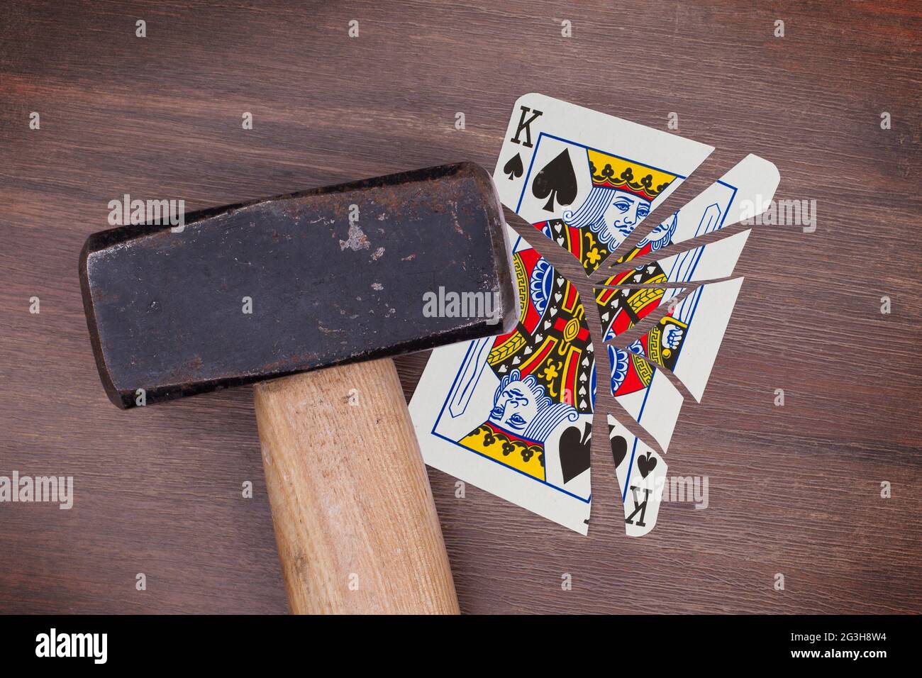 Hammer with a broken card, king of spades Stock Photo Alamy