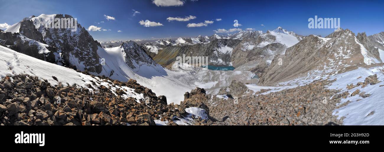 Scenic panorama of lake below highest mountain peaks in Ala Archa national park in Tian Shan mountain range in Kyrgyzstan Stock Photo