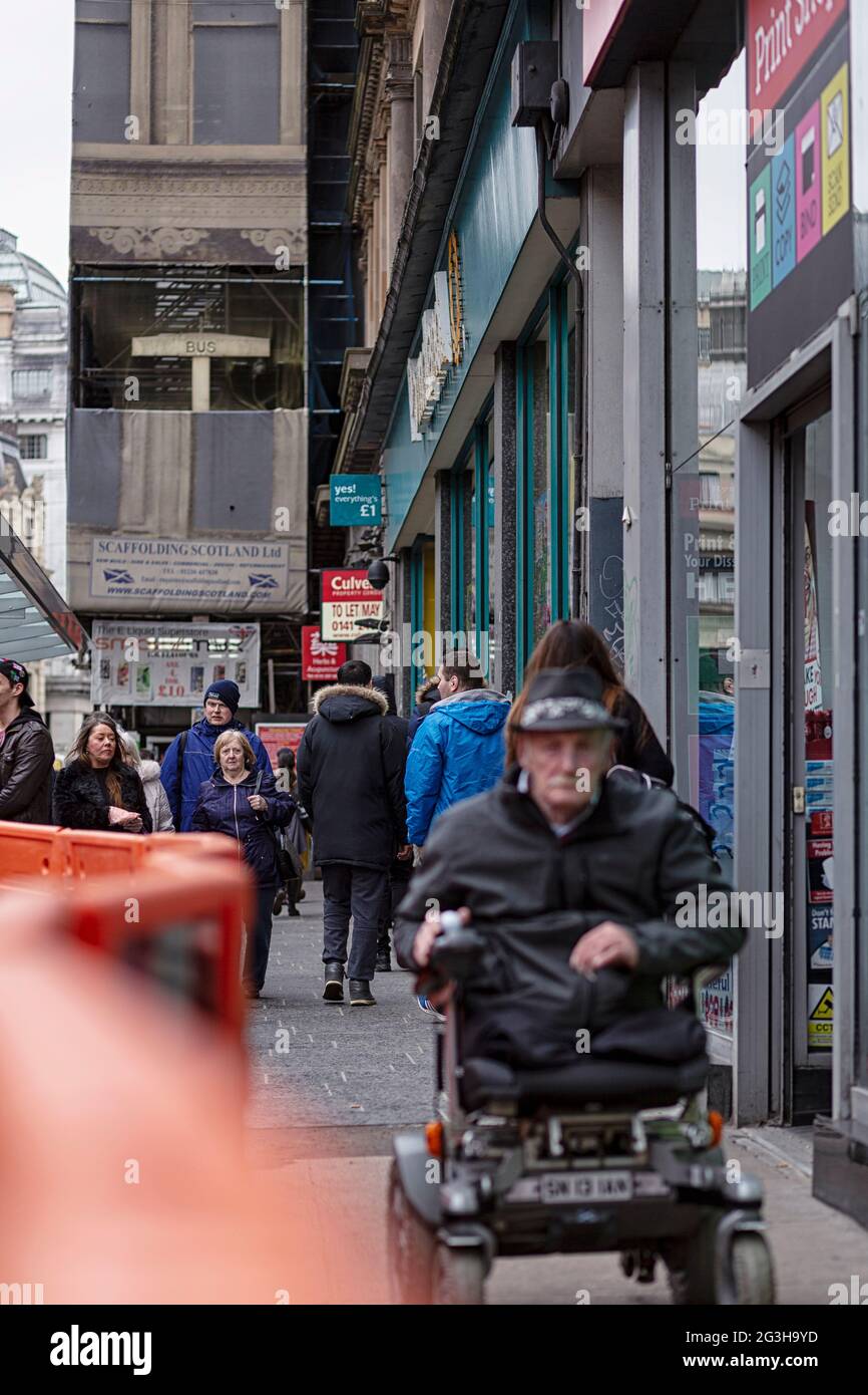 Man in wheelchair, Union Street, Glasgow, Scotland Stock Photo Alamy