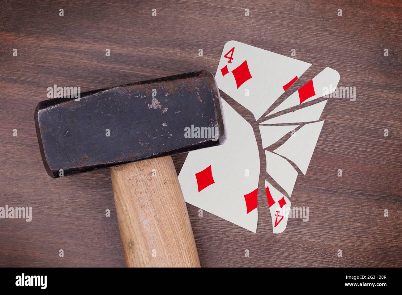 Hammer with a broken card, four of diamonds Stock Photo Alamy
