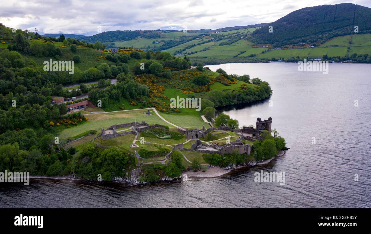Urquhart Castle, Loch Ness, Scotland, UK. 12 June 2021. Pictured: Drone aerial photography view from above of Urquhart Castle, a ruin, sits beside Loch Ness in the Highlands of Scotland. The castle is on the A82 road, 21 kilometres south-west of Inverness and 2 kilometres east of the village of Drumnadrochit. Credit: Colin Fisher/Alamy Live News. Stock Photo