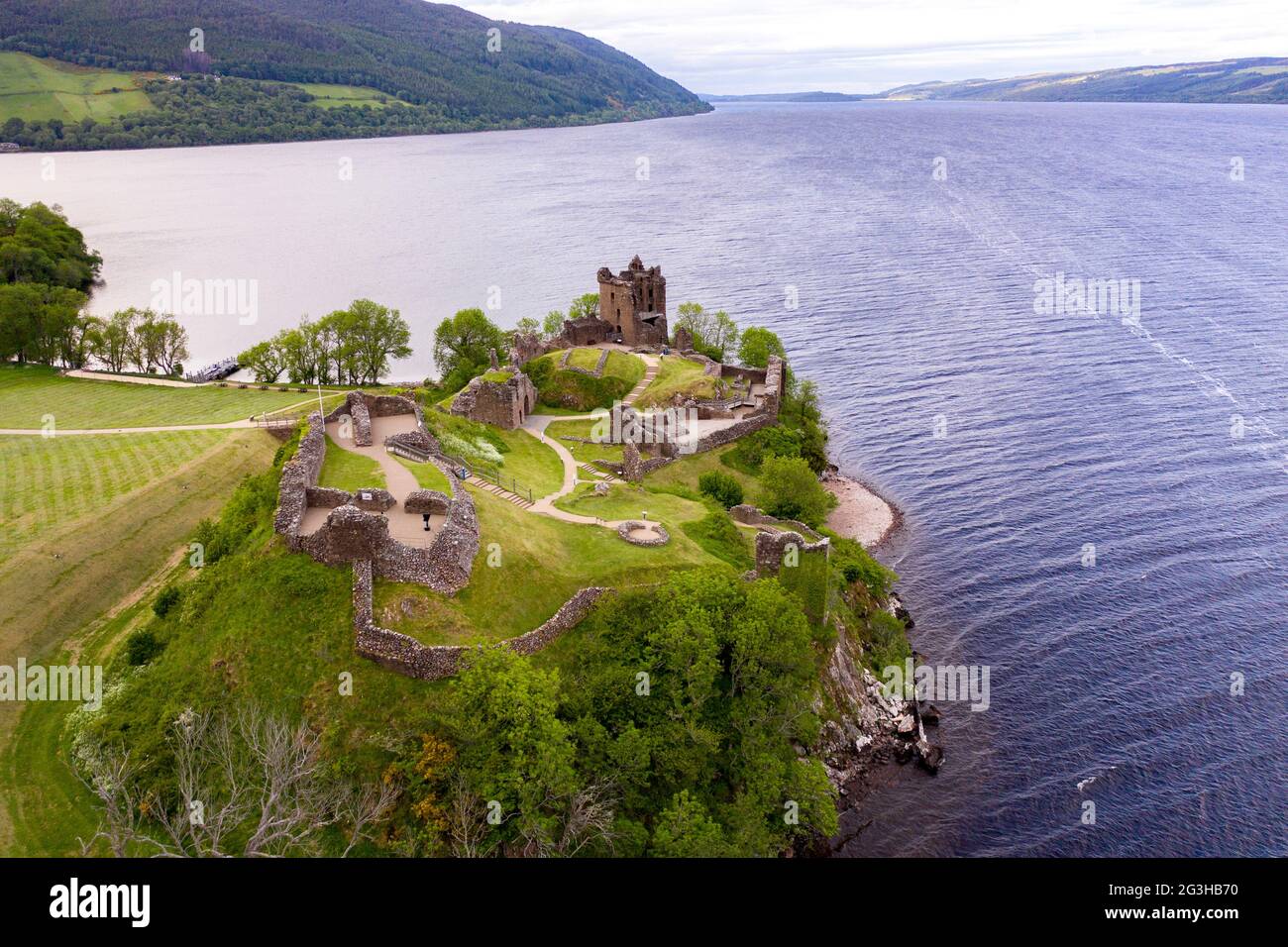 Urquhart Castle, Loch Ness, Scotland, UK. 12 June 2021. Pictured: Drone aerial photography view from above of Urquhart Castle, a ruin, sits beside Loch Ness in the Highlands of Scotland. The castle is on the A82 road, 21 kilometres south-west of Inverness and 2 kilometres east of the village of Drumnadrochit. Credit: Colin Fisher/Alamy Live News. Stock Photo