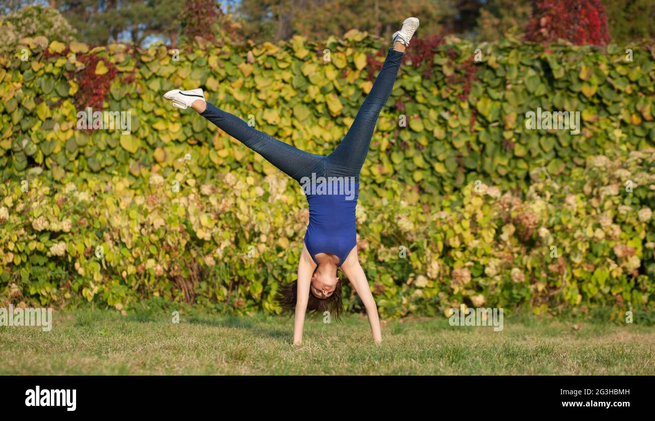 Sporty woman show cartwheel Stock Photo
