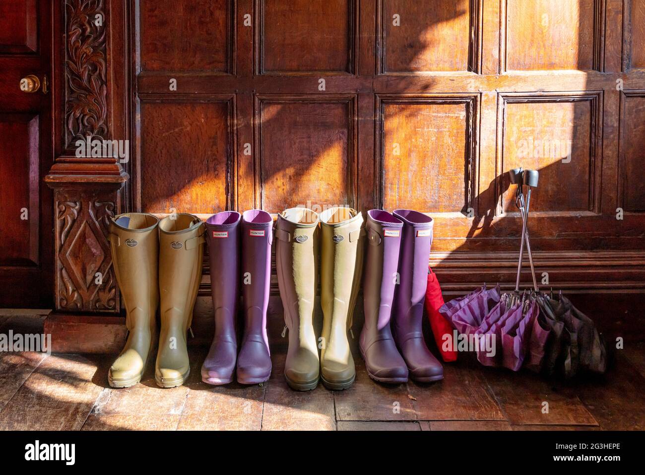 Wellies and umbrellas at front entrance to Manor House Hotel, Castle Combe, Wiltshire, England, UK Stock Photo