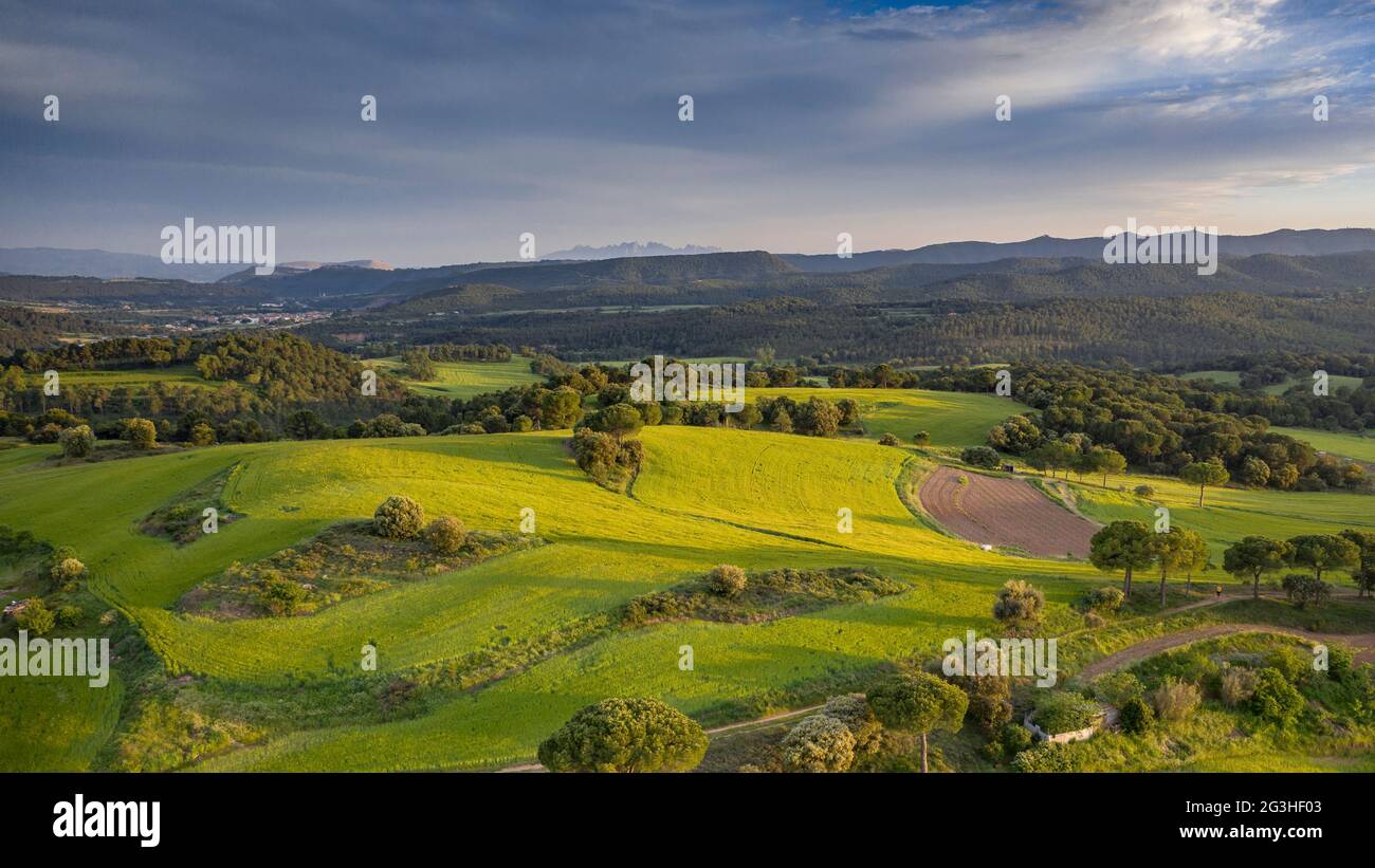Aerial view of the green fields and surroundings near Navàs on a spring sunset (Bages, Barcelona, Catalonia, Spain) ESP: Vista aérea de campos verdes Stock Photo