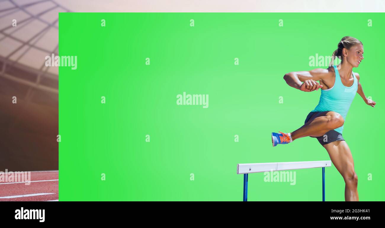 Caucasian female athlete jumping over a hurdle against green screen and ...