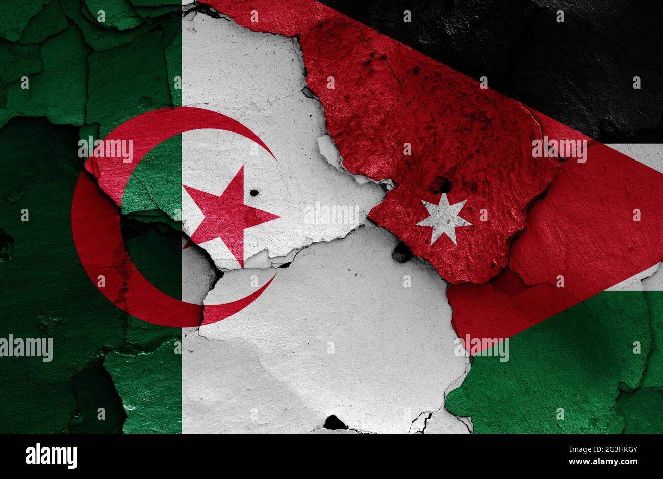 flags of Algeria and Jordan painted on cracked wall Stock Photo