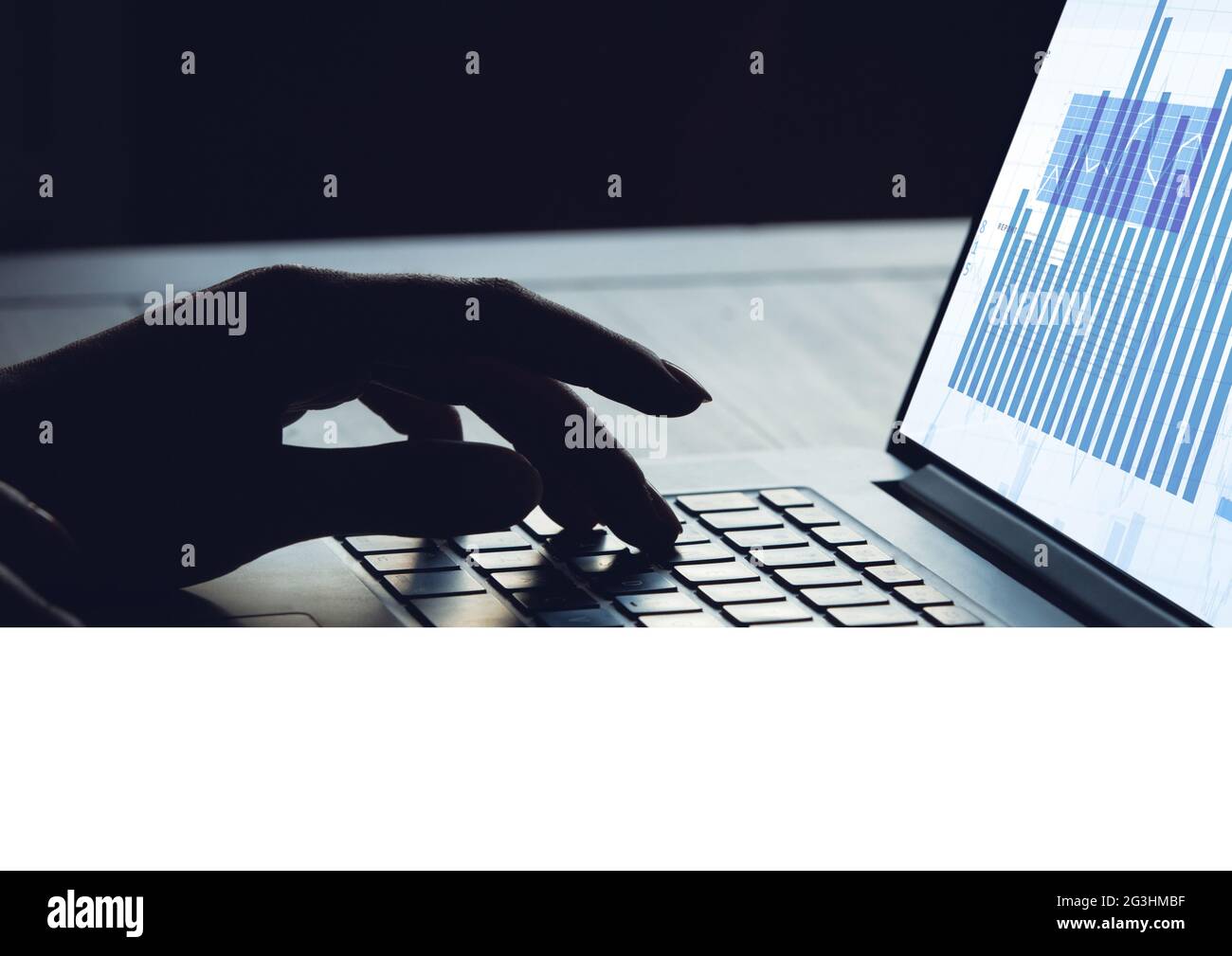 Composition of hand on laptop keyboard with graph information interface ...