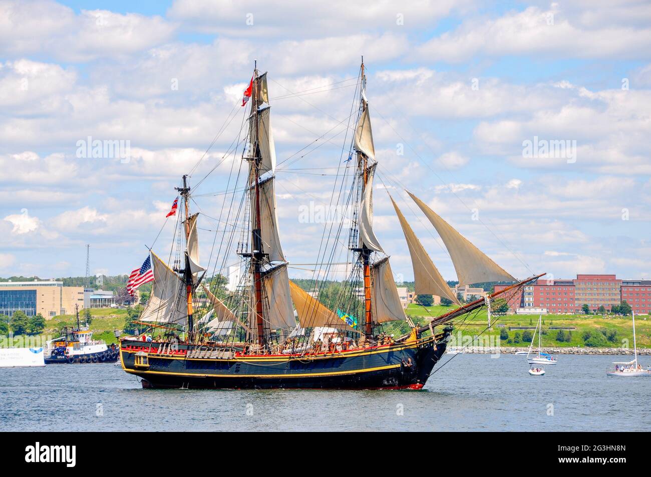 Seen during the Tall Ships parade at Halifax Harbour three years before she was lost at sea, replica ship HMS Bounty at full sail. Stock Photo