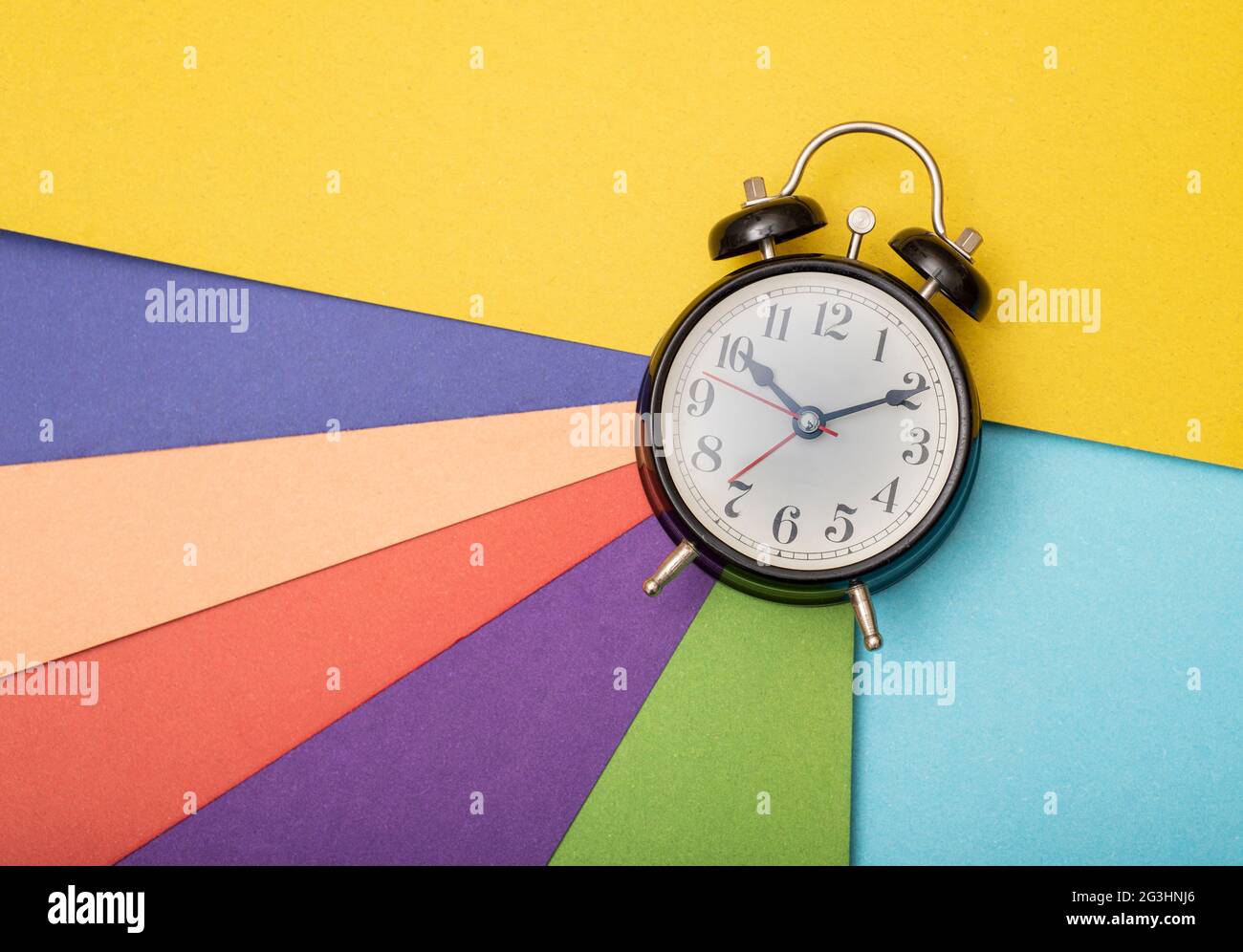 Time management concept with multi color cards in background. Stock Photo