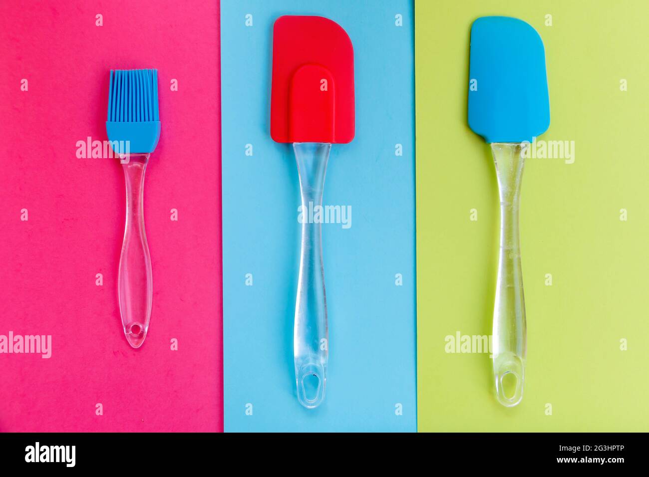 Silicone kitchen utensils on a tricolor background Stock Photo