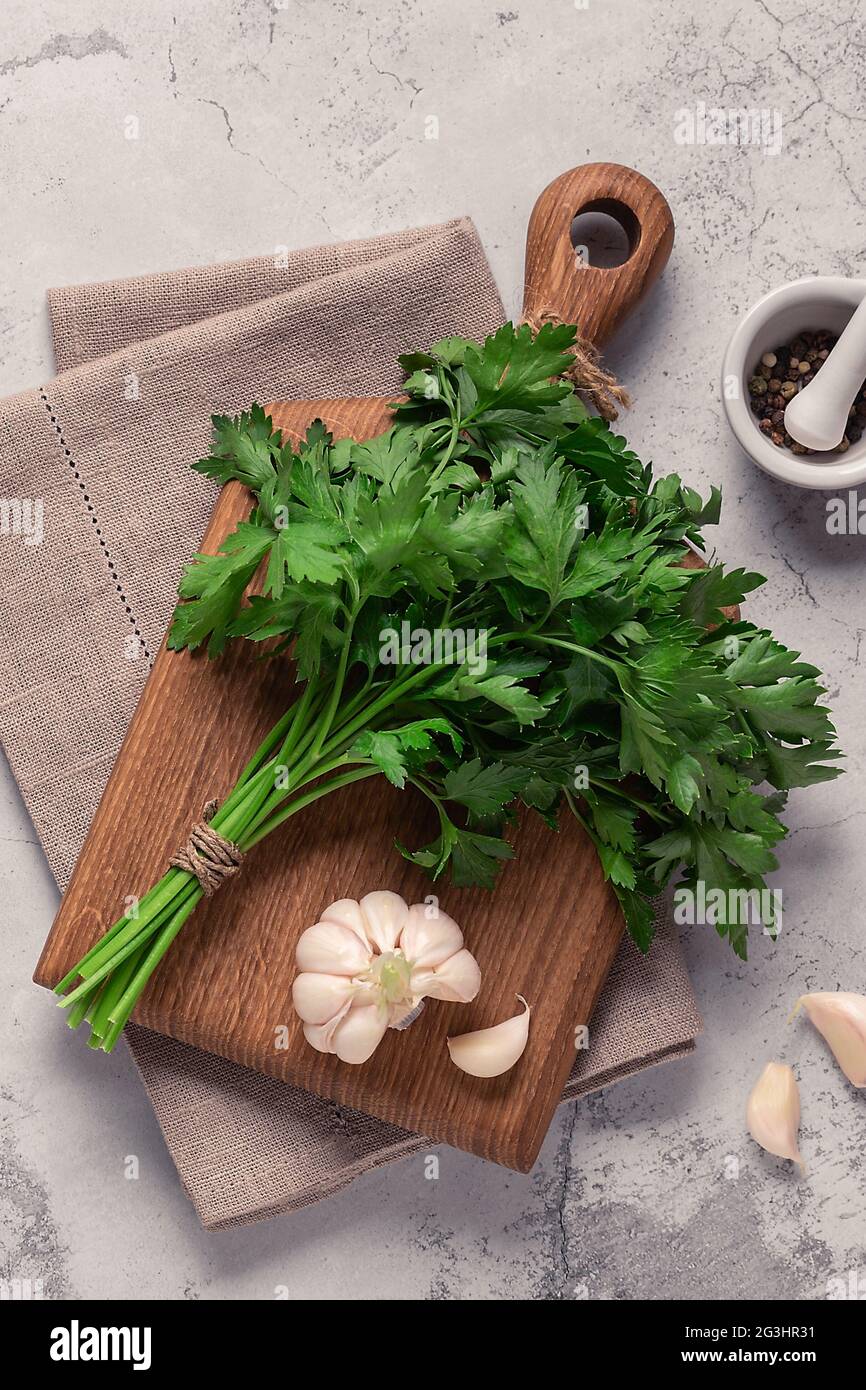 cutting board, parsley on a concrete table, top view Stock Photo