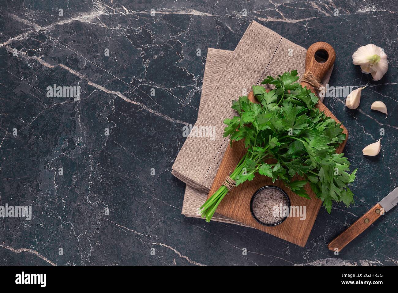 cutting board, parsley on a marble table, top view Stock Photo