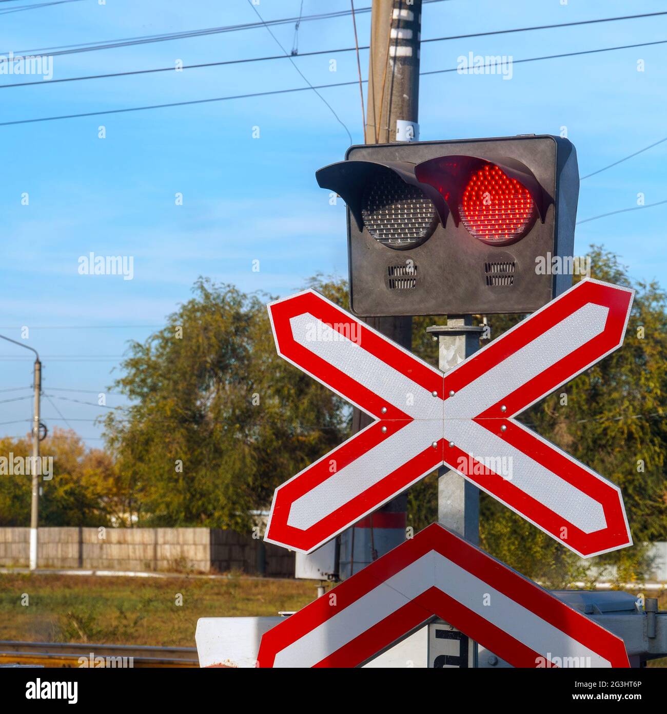 Traffic light or semaphore flashing red at a railway crossing Stock