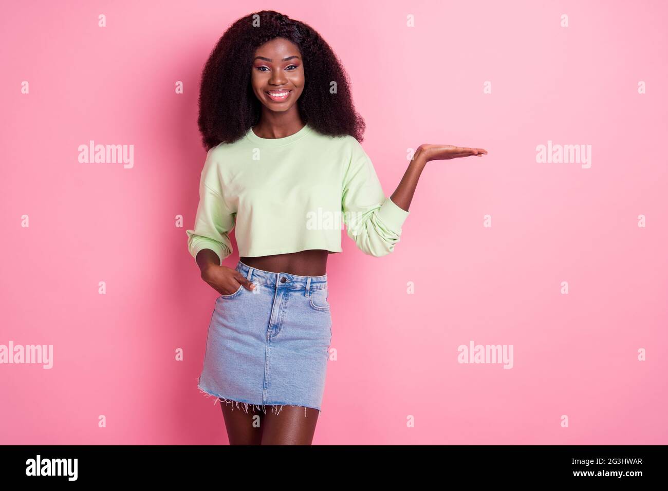 Photo of beautiful happy dark skin woman hold hand empty space