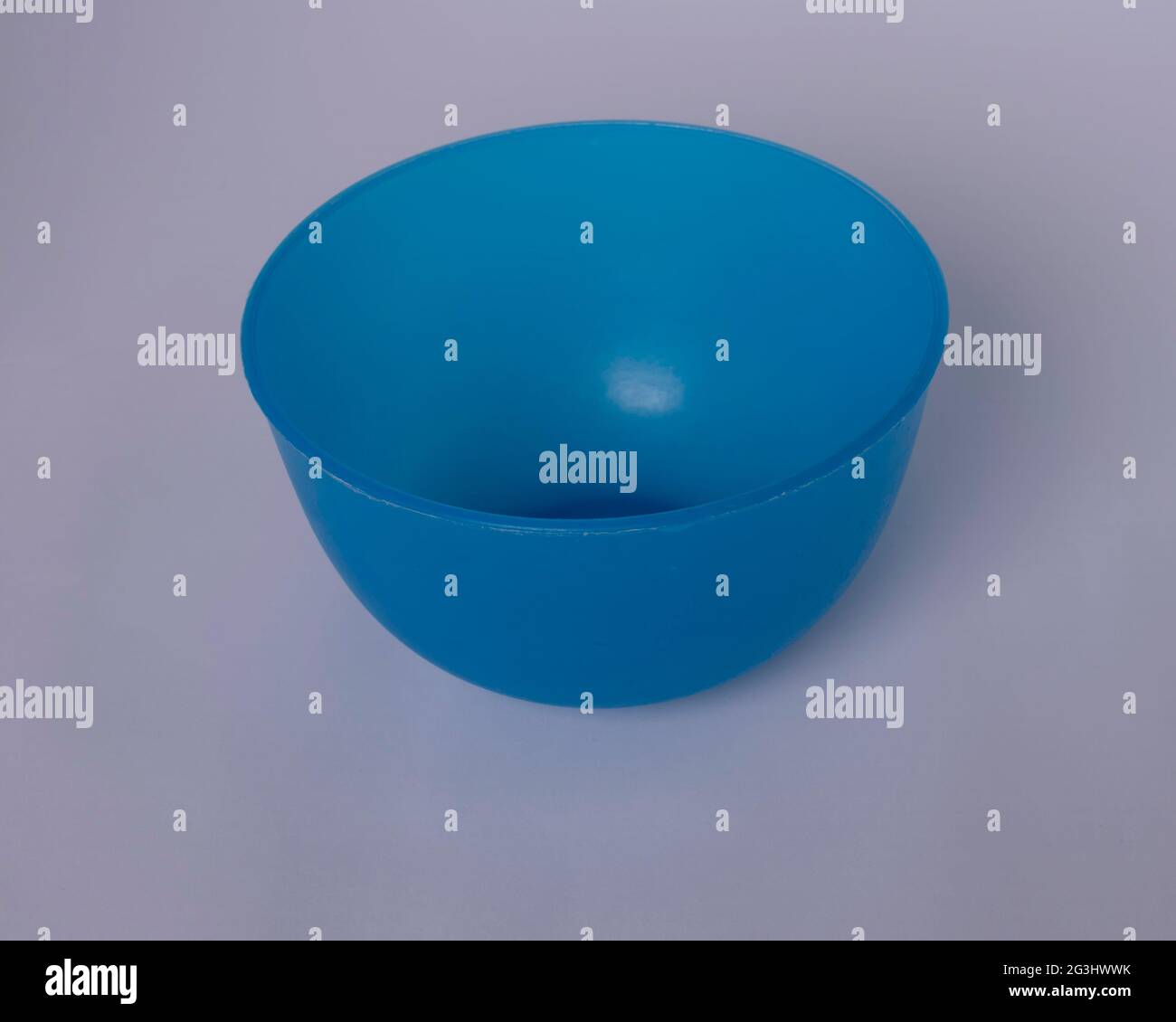Blue bright bowl in a white , grayish background Stock Photo
