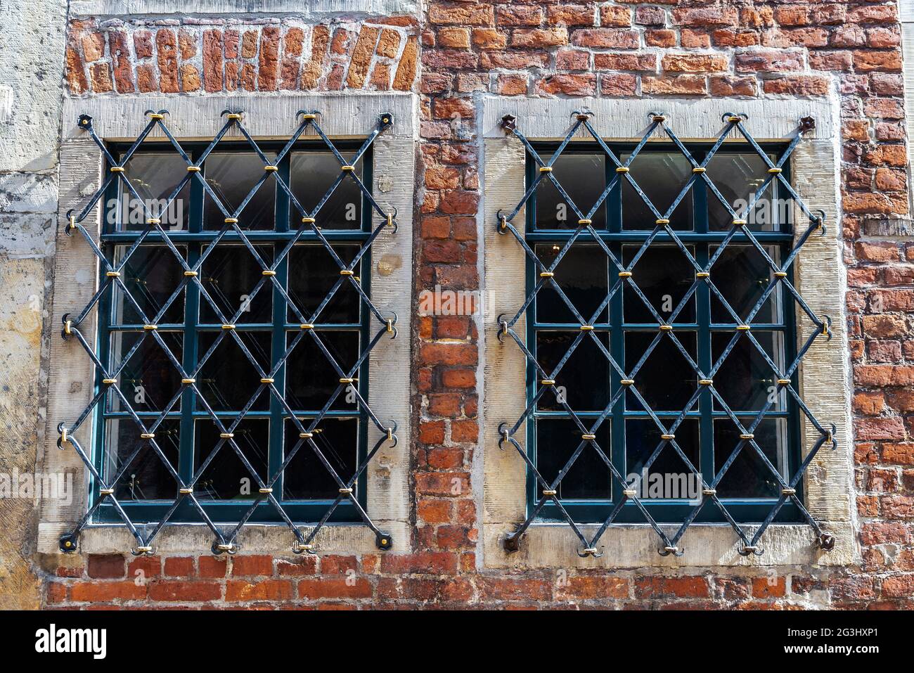 Barred windows of an old brick house in Böttcherstraße, Bremen, Germany Stock Photo
