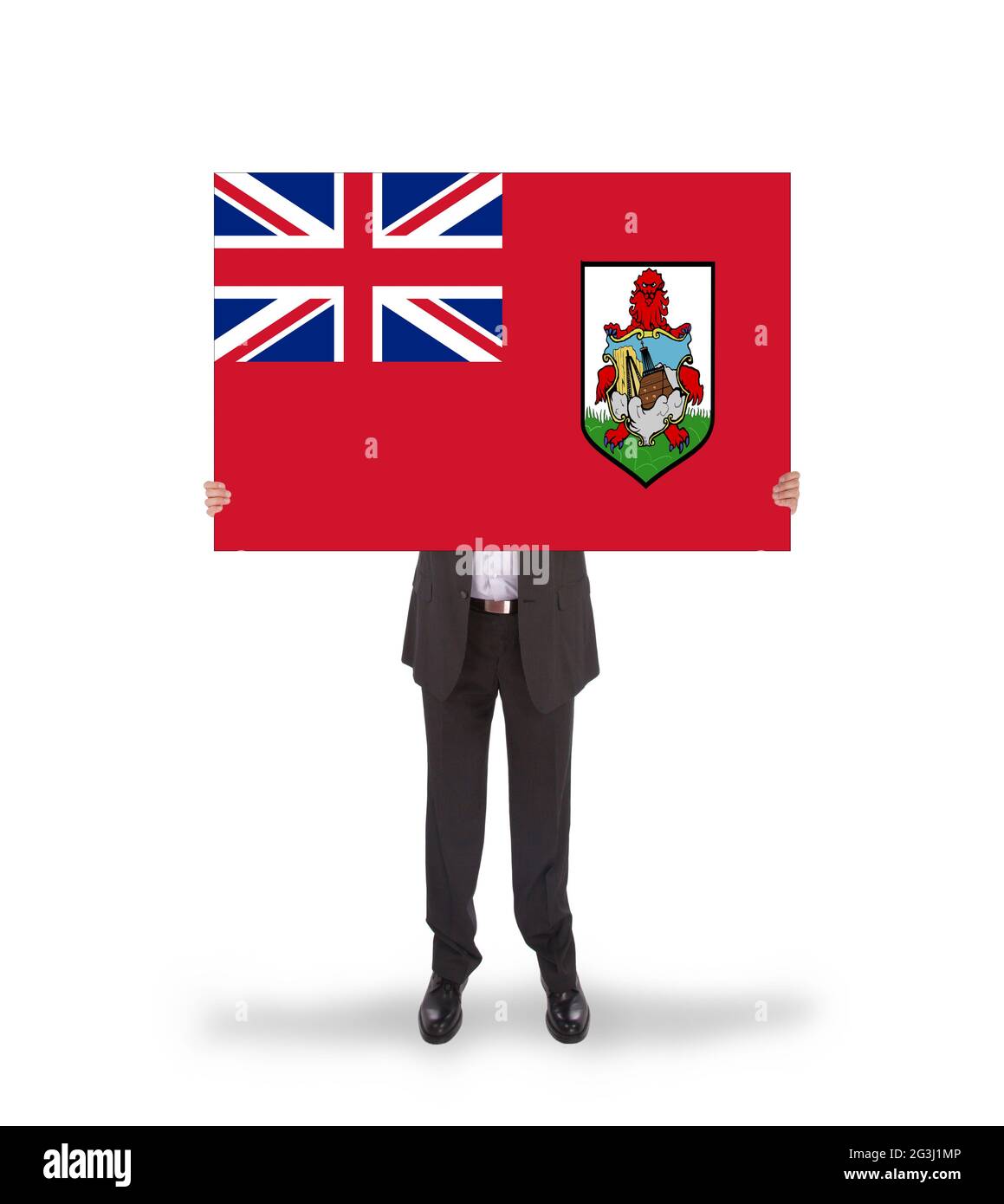 Smiling businessman holding a big card, flag of Bermuda Stock Photo