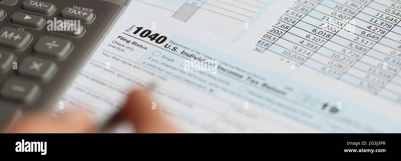 On table is tax deduction form and calculator Stock Photo