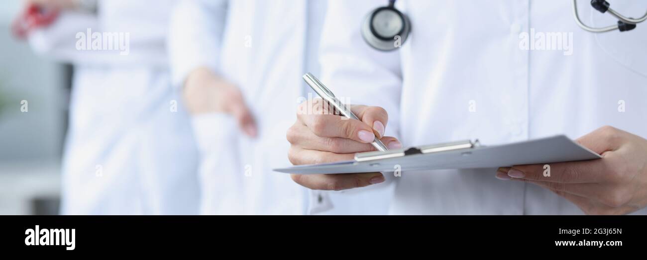Doctors in white medical coats stand together Stock Photo Alamy