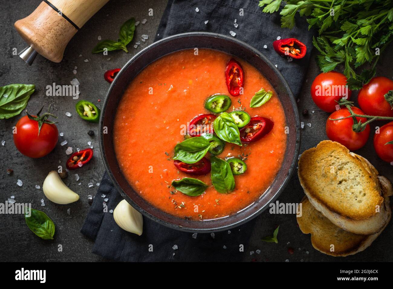 Tomato soup at black table top view Stock Photo - Alamy