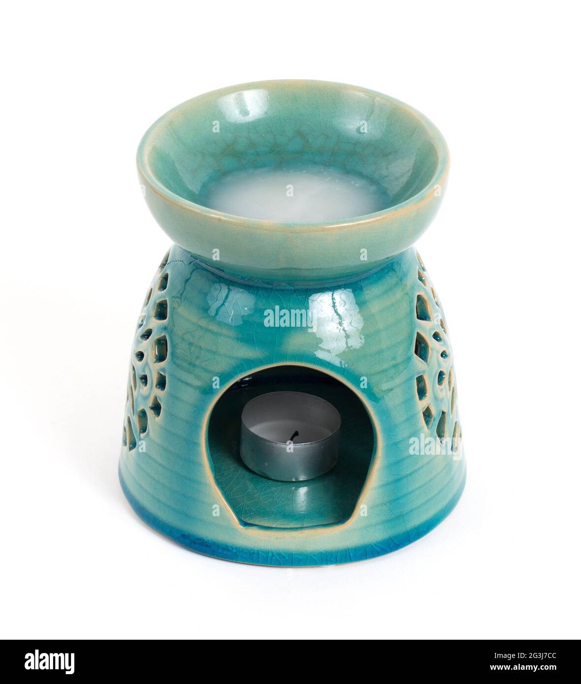 Candle in oil burner Stock Photo