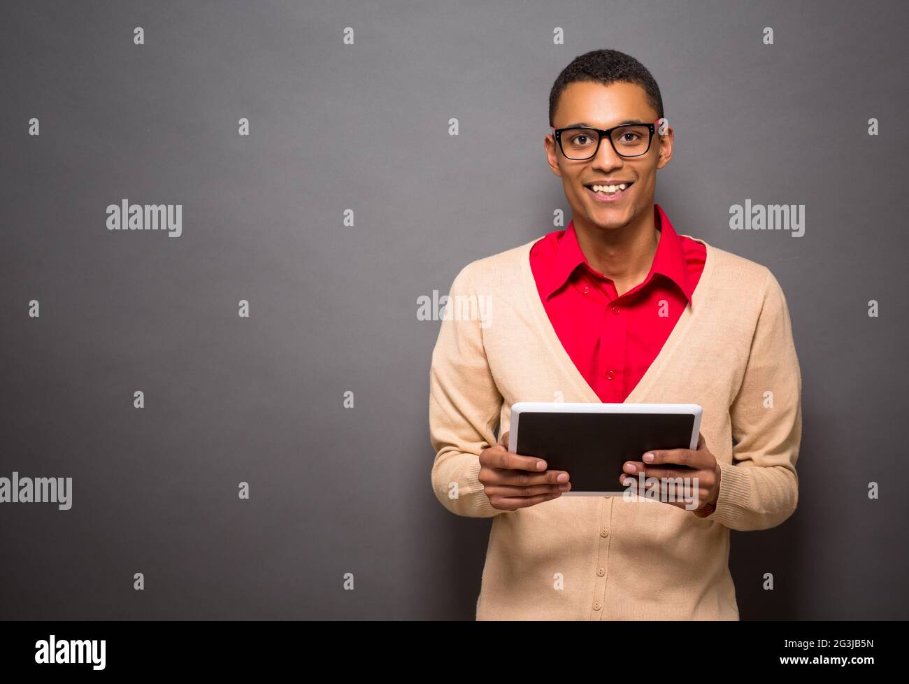 Handsome latin man with tablet PC in studio Stock Photo