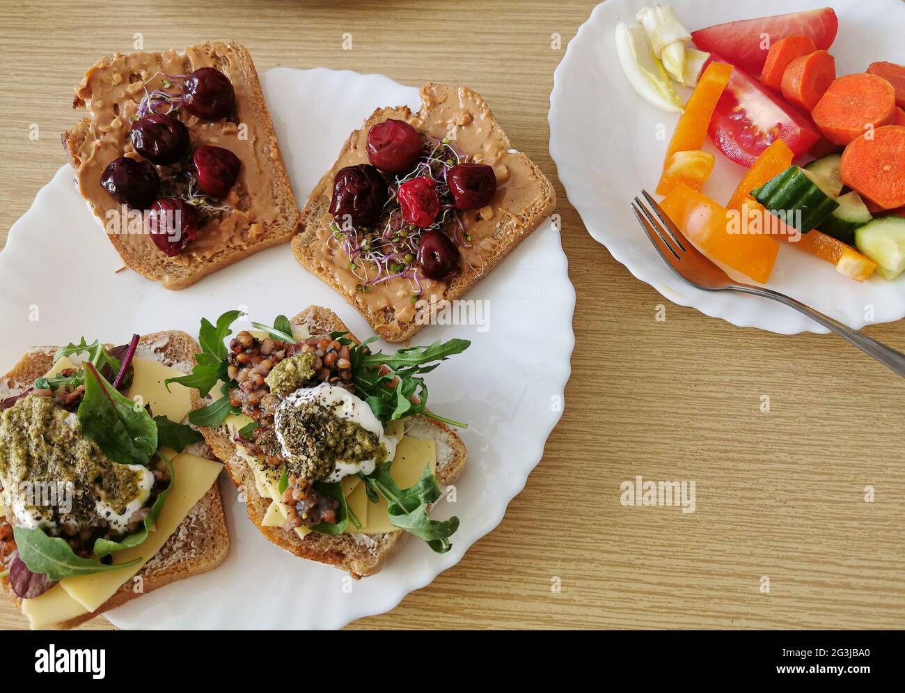 Four healthy sandwiches with dark wholemeal bread. Two savory and two