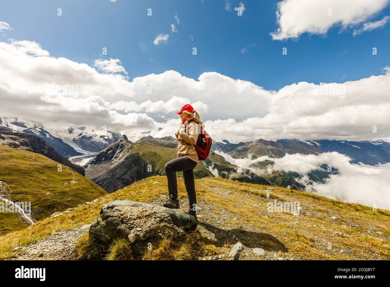 Rear view of a woman with backpack looking at the view Female hiker ...