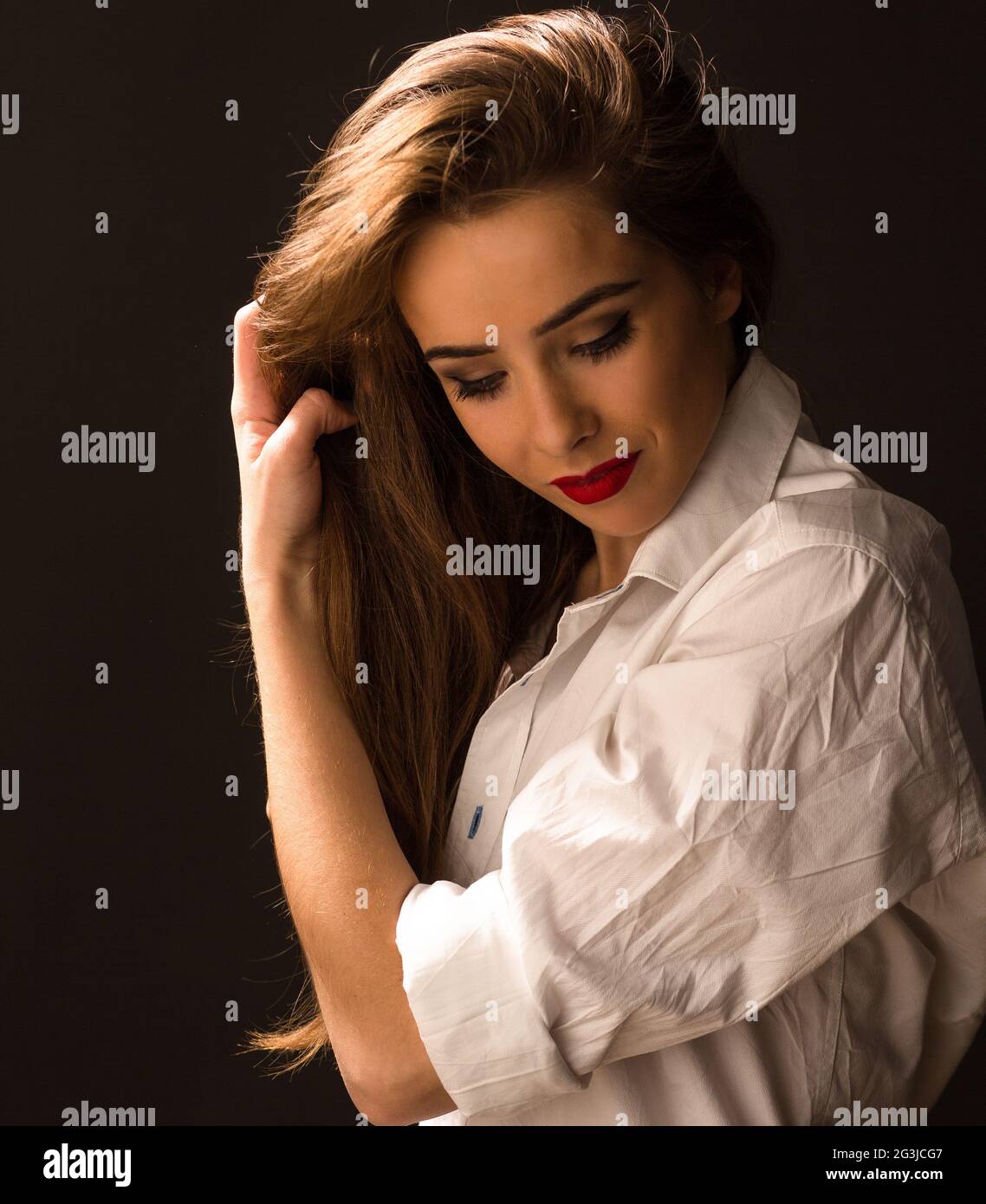 Beautiful lady in white shirt in studio Stock Photo