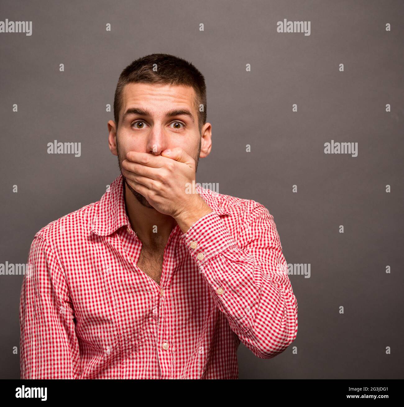 Man covering his mouth Stock Photo Alamy