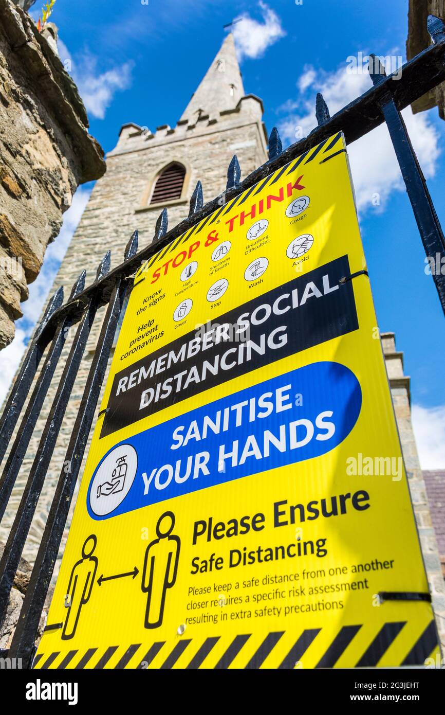 Letterkenny, County Donegal, Ireland. 16th June 2021. Signage on a church gate reminds visitors of the need to social distance and sanitise hands if they wish to visit the church. Stock Photo