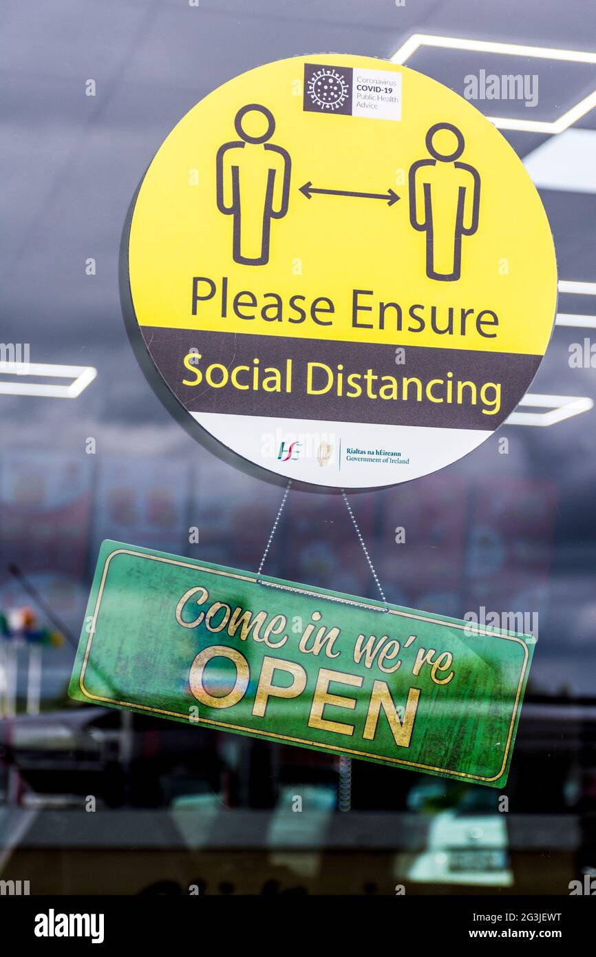Letterkenny, County Donegal, Ireland. 16th June 2021. Signage on a takeaway restaurant says 'Come in We're Open' as well as a warning about social distancing on the premises. Stock Photo