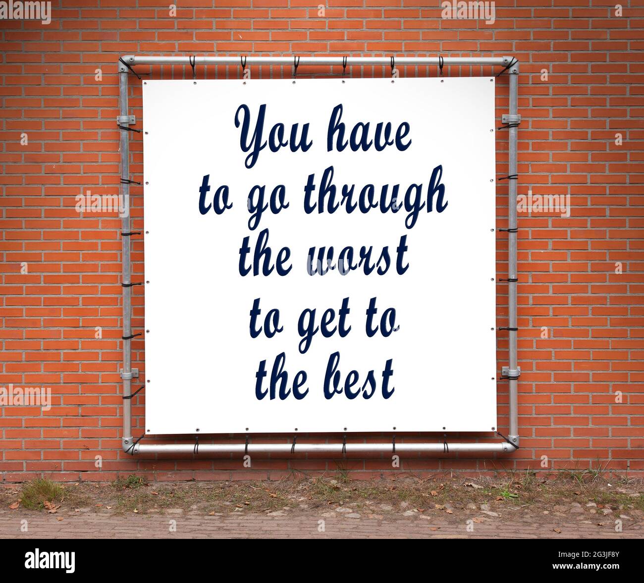 Large banner with inspirational quote on a brick wall Stock Photo - Alamy