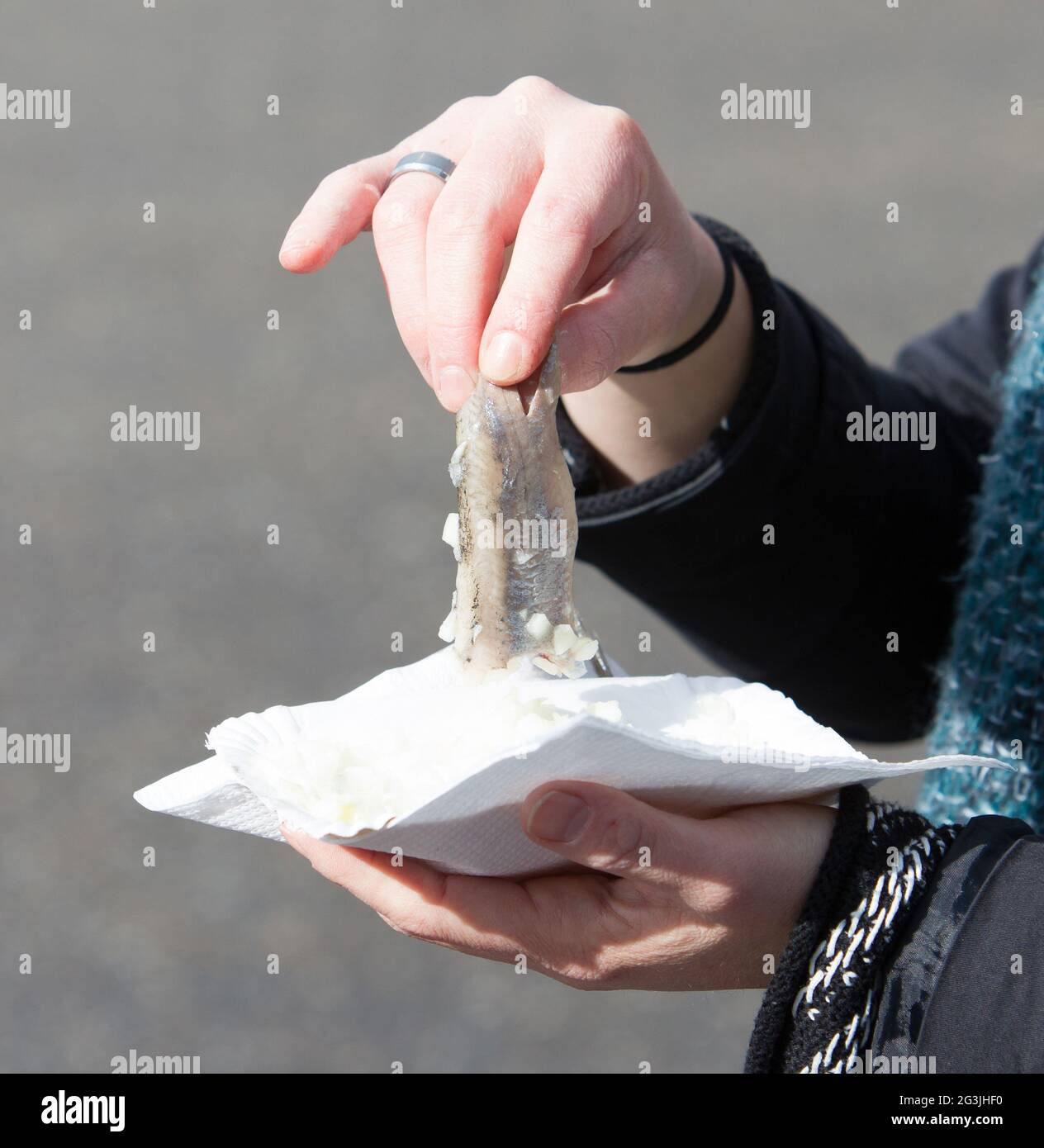 Dutch woman is eating typical raw herring Stock Photo Alamy