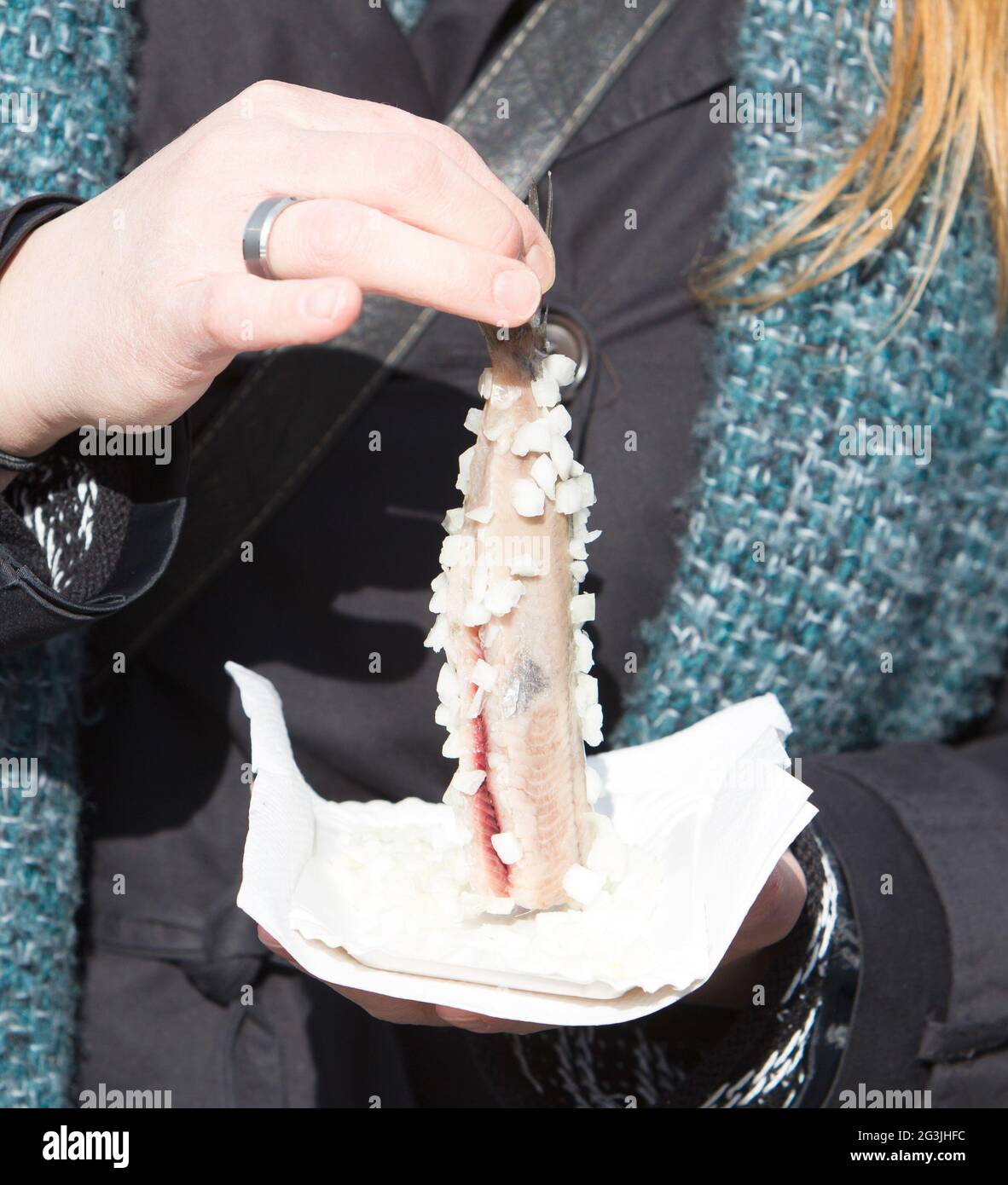 Dutch woman is eating typical raw herring Stock Photo Alamy