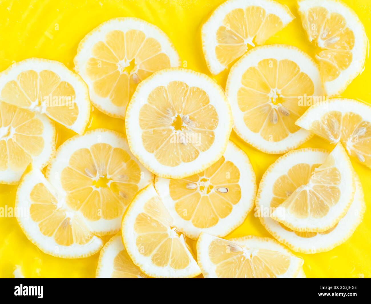 Lemon citrus slices in water with ripples, bold yellow texture summer ...