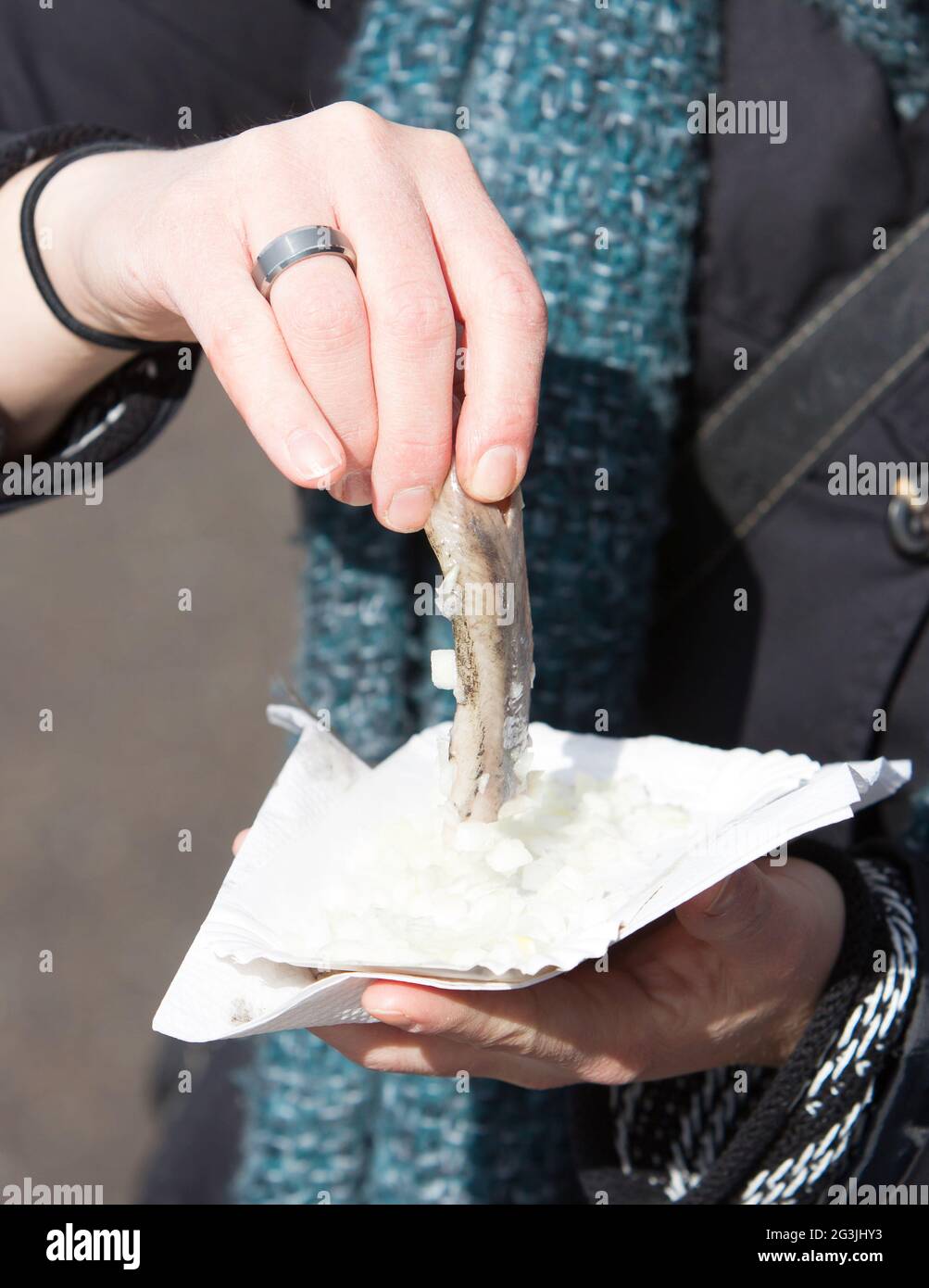 Dutch woman is eating typical raw herring Stock Photo Alamy