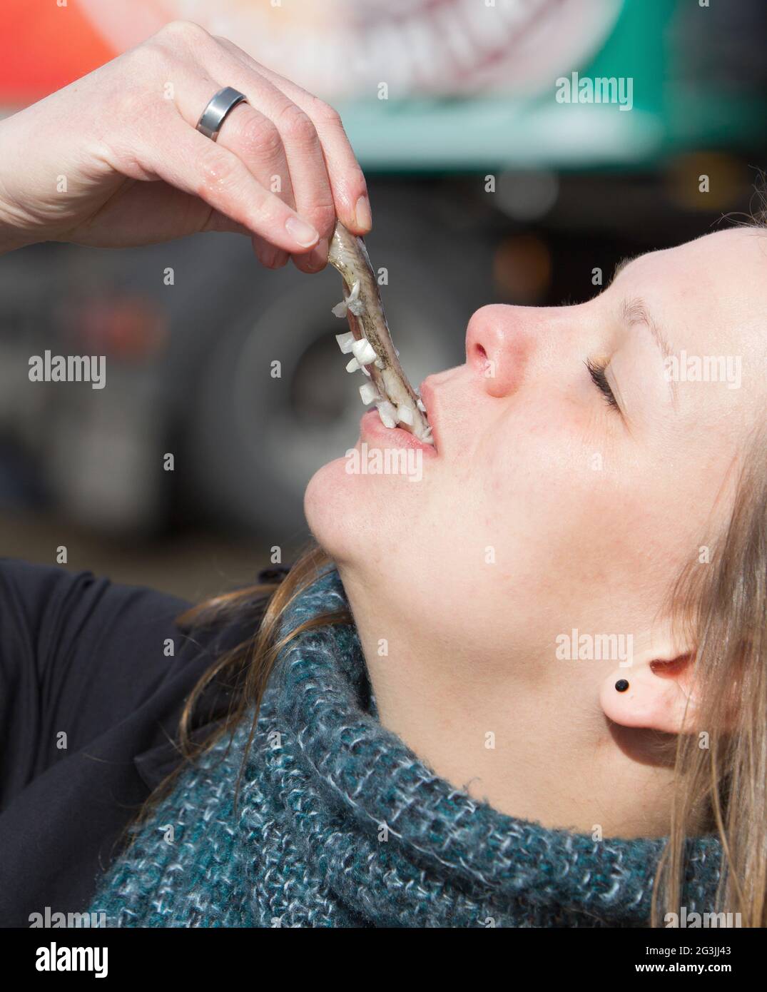 Dutch woman is eating typical raw herring Stock Photo Alamy