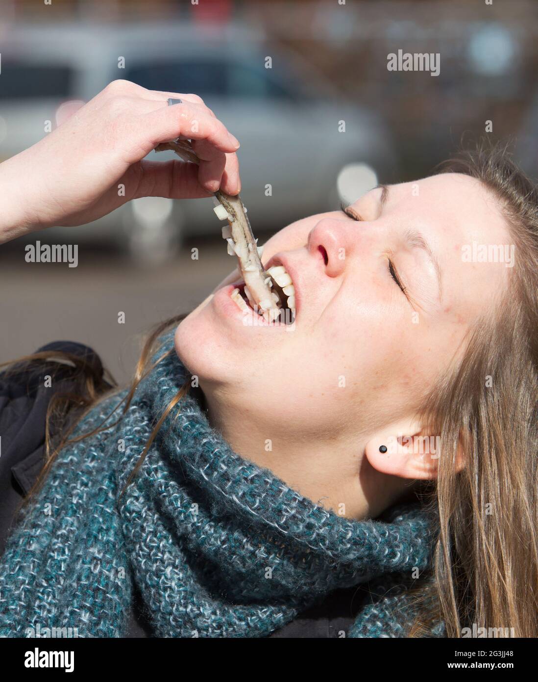 Dutch woman is eating typical raw herring Stock Photo Alamy
