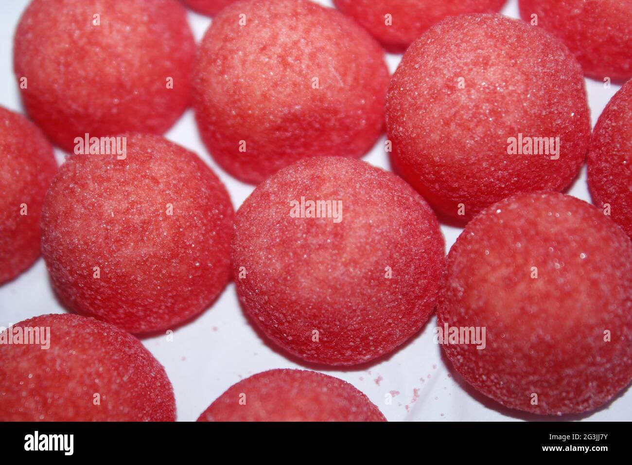 Red strawberry candies on white background Stock Photo - Alamy