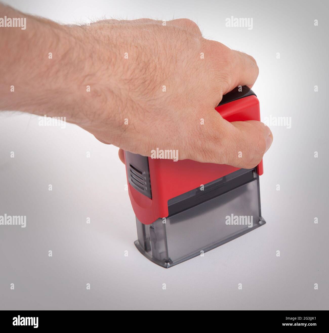 Plastic stamp in hand, isolated Stock Photo Alamy