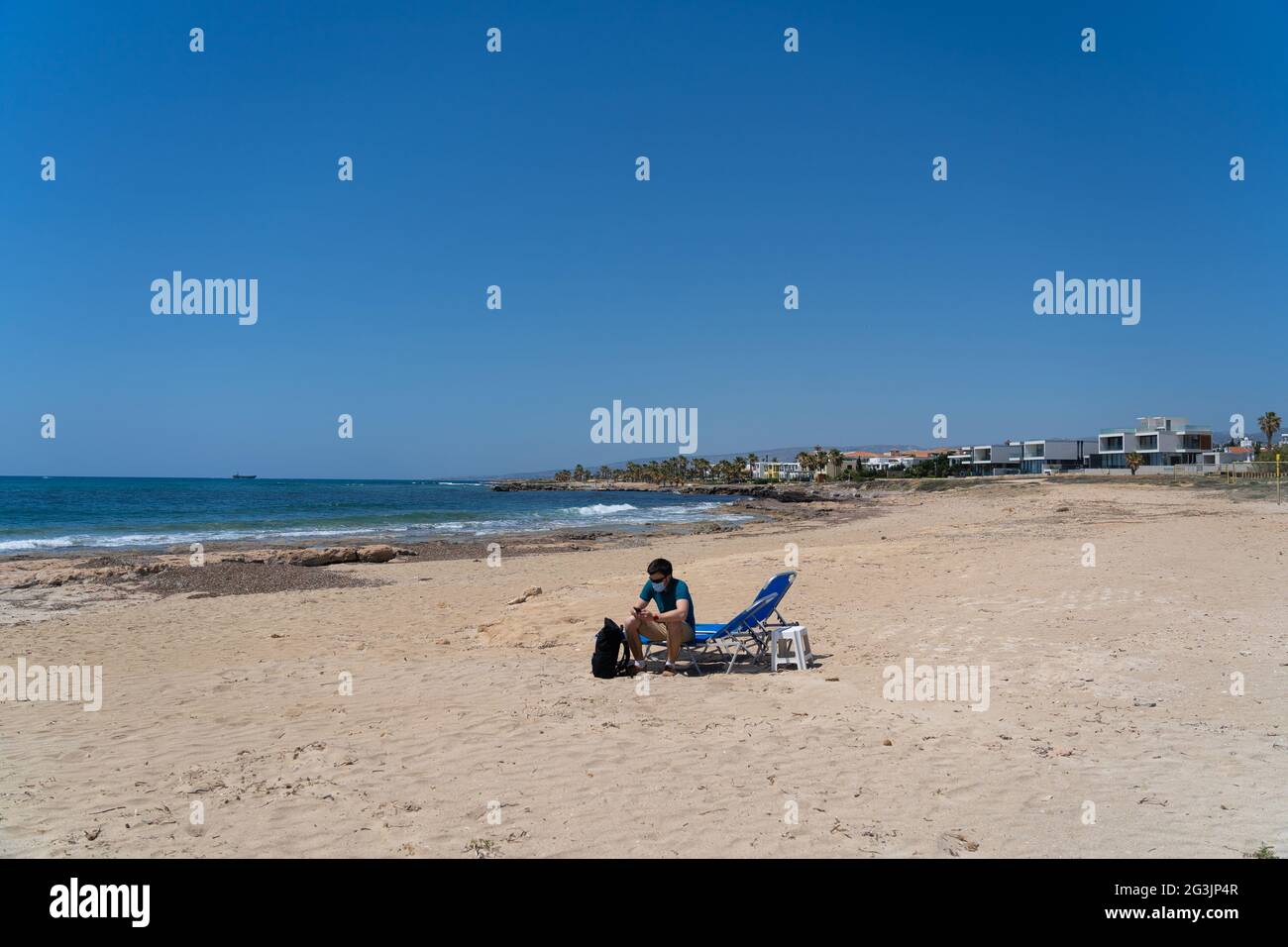 New normal in vacation in time after COVID19 pandemic. Sad man wearing