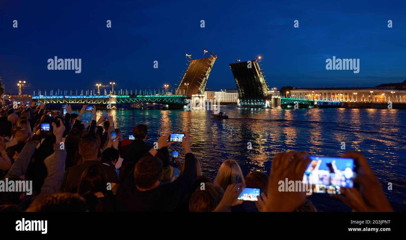 Russia, St. Petersburg, people who came to see the bridges being built shoot what is happening on their mobile phones. Stock Photo