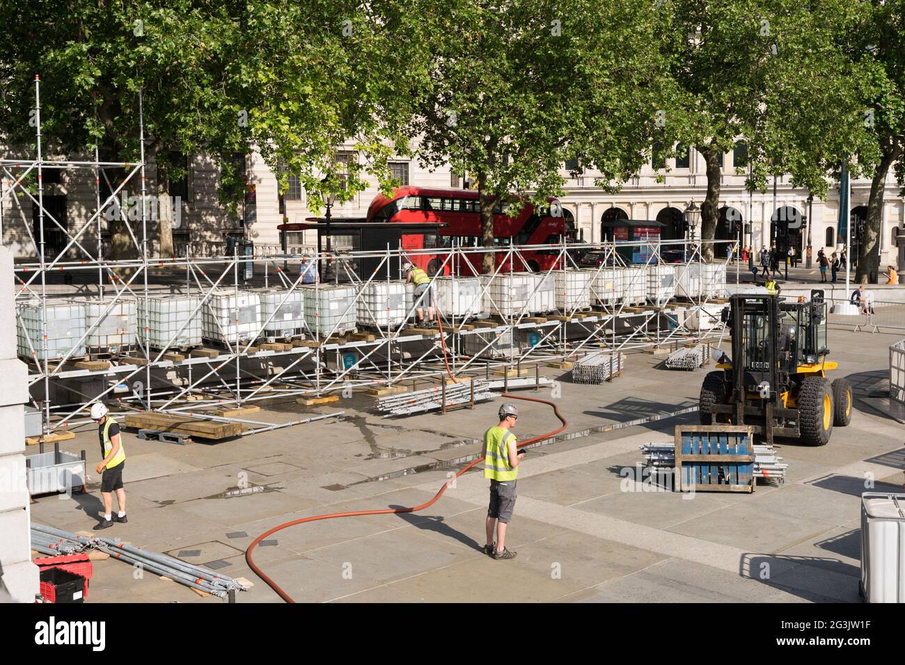 Builders construct the fences around Trafalgar square for UEFA festival, EURO2020 foot season, England, UK Stock Photo